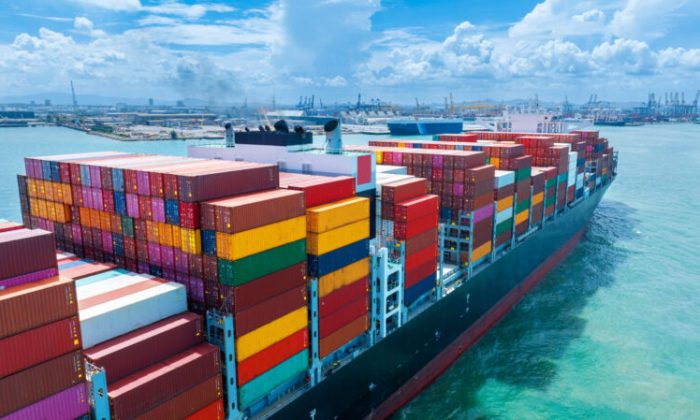 Stern of large cargo container ship import export container box on the ocean sea on blue sky back ground concept transportation logistic and service to customer and supply change.